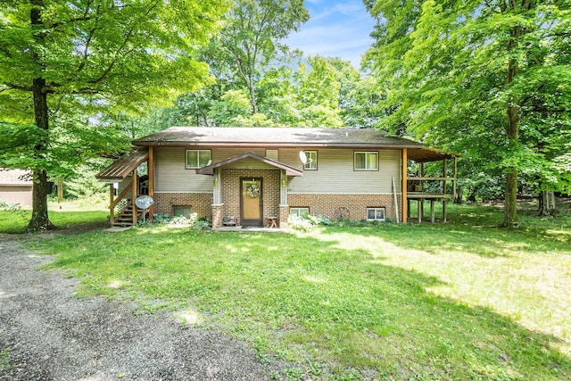 4424 Teal Ln, Newaygo, MI 49337 - split foyer home featuring a front lawn and brick siding