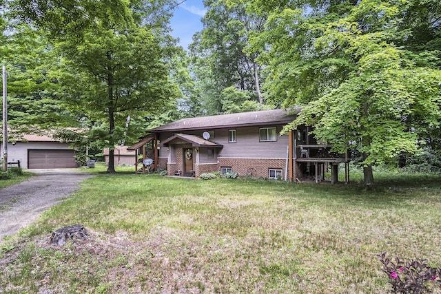4424 Teal Ln, Newaygo, MI 49337 - view of front of house featuring an outdoor structure, a front lawn, and a detached garage