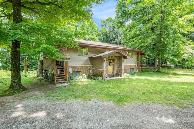 4424 Teal Ln, Newaygo, MI 49337 - bi-level home featuring brick siding, stairway, and a front yard