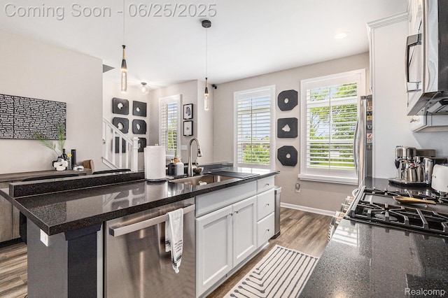 475 Jenny Way, Brighton, MI 48116 - kitchen featuring appliances with stainless steel finishes, white cabinetry, hanging light fixtures, and a center island with sink