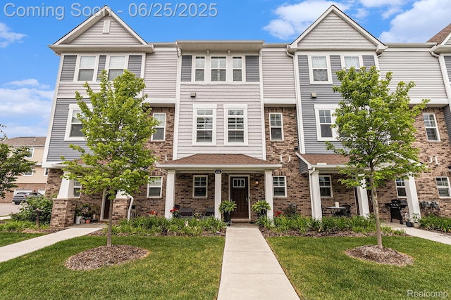 475 Jenny Way, Brighton, MI 48116 - view of property with a front lawn and brick siding
