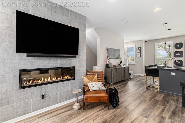 475 Jenny Way, Brighton, MI 48116 - living area featuring wood finished floors, a tiled fireplace, and recessed lighting