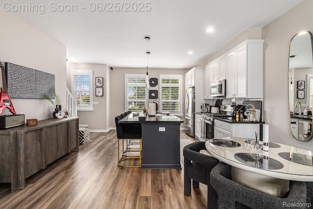 475 Jenny Way, Brighton, MI 48116 - kitchen with appliances with stainless steel finishes, dark countertops, dark wood-style floors, white cabinetry, and recessed lighting