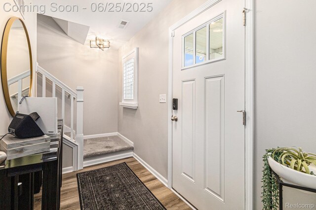 475 Jenny Way, Brighton, MI 48116 - foyer entrance featuring wood finished floors, a chandelier, and stairs