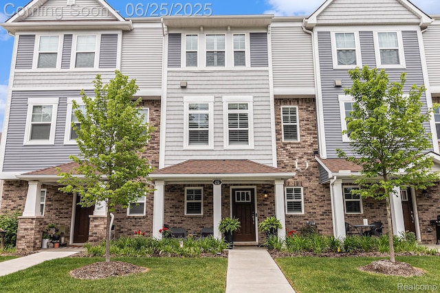 475 Jenny Way, Brighton, MI 48116 - view of property featuring brick siding and a front lawn