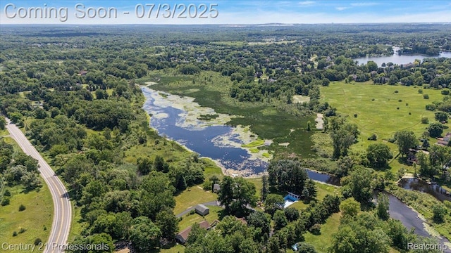 291 N Baldwin Rd, Clarkston, MI 48348 - aerial overview of property's location featuring a large body of water and a heavily wooded area