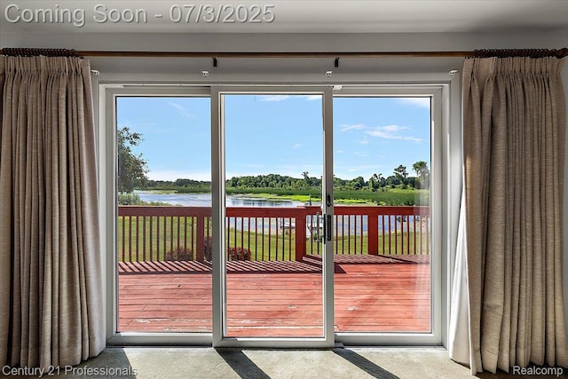 291 N Baldwin Rd, Clarkston, MI 48348 - doorway featuring a water view, plenty of natural light, and carpet