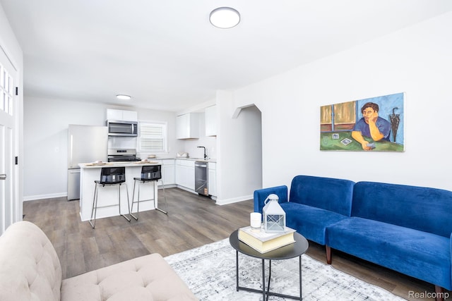 1730 E Hazelhurst St, Ferndale, MI 48220 - living area featuring dark wood-type flooring and baseboards