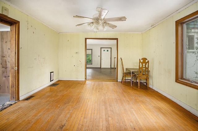 9563 Oak Rd, Willis, MI 48191 - spare room featuring light wood-style flooring, ceiling fan, and ornamental molding