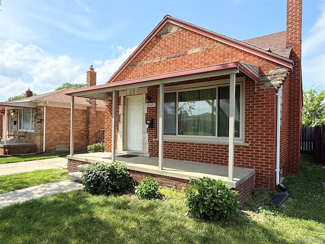 8121 Marian St, Warren, MI 48093 - bungalow featuring covered porch, a chimney, and brick siding