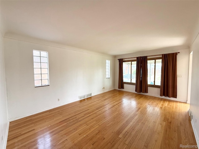 8121 Marian St, Warren, MI 48093 - empty room featuring light wood-type flooring and plenty of natural light