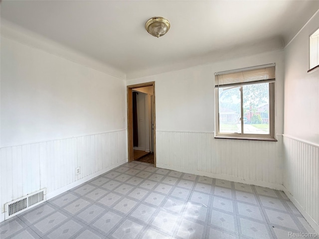 8121 Marian St, Warren, MI 48093 - empty room featuring a wainscoted wall and light floors