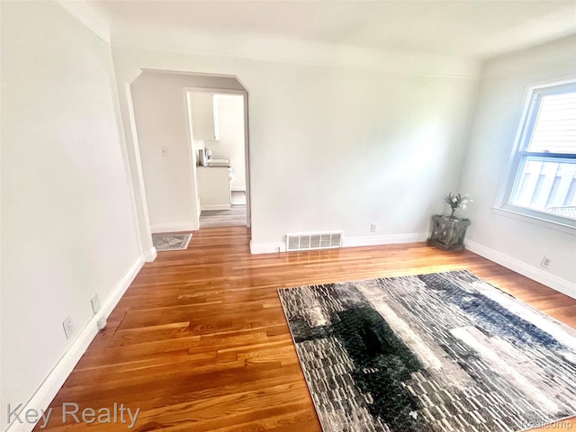 13509 Backus St, Southgate, MI 48195 - spare room featuring wood finished floors and arched walkways