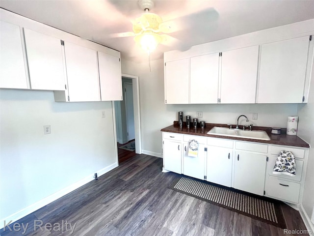 13509 Backus St, Southgate, MI 48195 - kitchen featuring dark countertops, dark wood-type flooring, ceiling fan, and white cabinetry