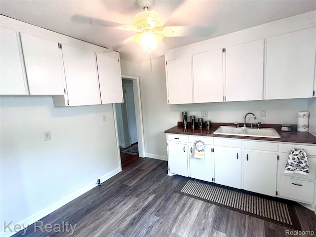 13509 Backus St, Southgate, MI 48195 - kitchen with white cabinets, dark wood-type flooring, a ceiling fan, and dark countertops