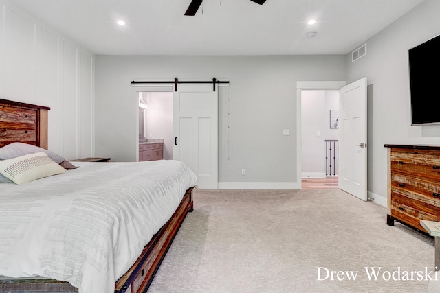 8205 Autumn Acres Dr, Rockford, MI 49341 - bedroom with a barn door, light colored carpet, recessed lighting, ceiling fan, and ensuite bath