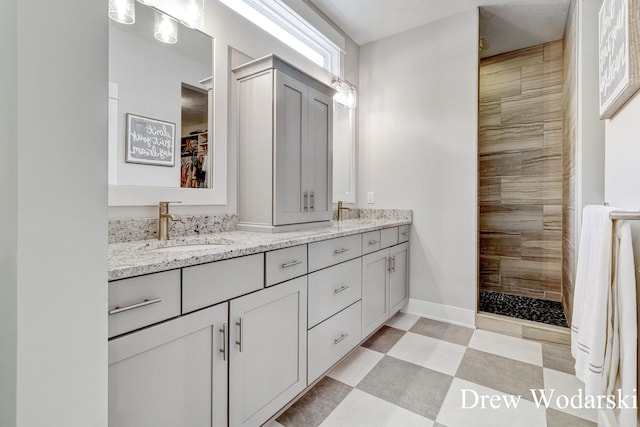 8205 Autumn Acres Dr, Rockford, MI 49341 - full bathroom with double vanity, a walk in shower, tile patterned floors, and a walk in closet