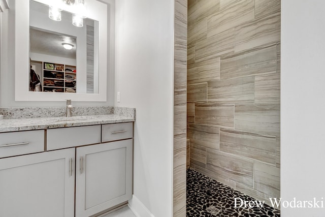 8205 Autumn Acres Dr, Rockford, MI 49341 - full bath featuring marble finish floors, vanity, and tiled shower