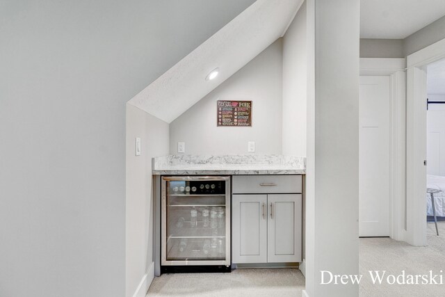8205 Autumn Acres Dr, Rockford, MI 49341 - indoor dry bar featuring wine cooler, light colored carpet, and lofted ceiling