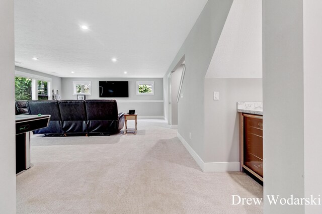 8205 Autumn Acres Dr, Rockford, MI 49341 - carpeted living area with wine cooler, recessed lighting, and a bar