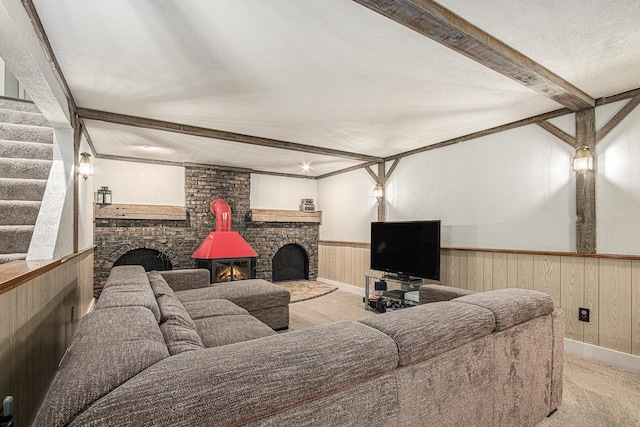 33370 Frantz Dr, Niles, MI 49120 - carpeted living area featuring beamed ceiling, a brick fireplace, wainscoting, stairs, and a textured ceiling