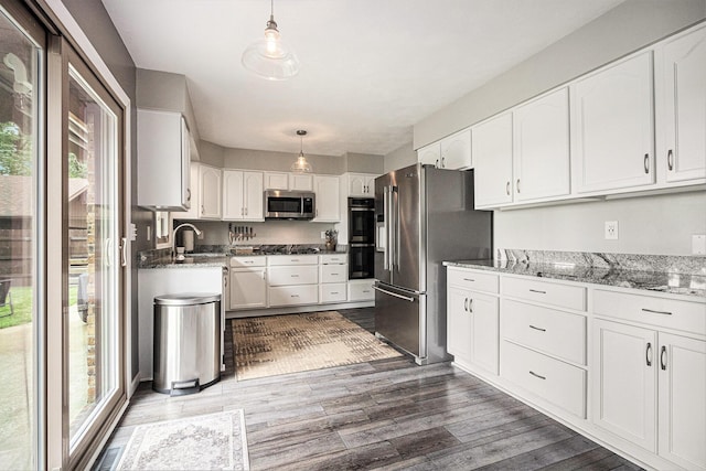 33370 Frantz Dr, Niles, MI 49120 - kitchen featuring appliances with stainless steel finishes, white cabinetry, light stone counters, and dark wood-style flooring