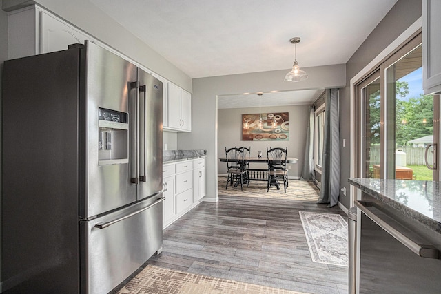 33370 Frantz Dr, Niles, MI 49120 - kitchen featuring high quality fridge, white cabinetry, light stone countertops, wood finished floors, and pendant lighting