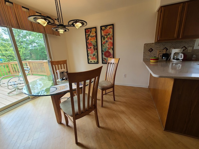 3393 Kevin Cir, Warren, MI 48092 - dining area with light wood finished floors and a chandelier
