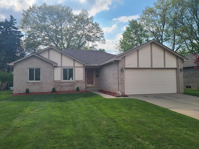 3393 Kevin Cir, Warren, MI 48092 - view of front facade with brick siding, a garage, driveway, and a front lawn