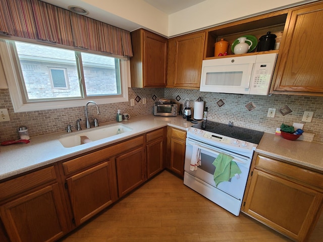 3393 Kevin Cir, Warren, MI 48092 - kitchen with white appliances, light wood-type flooring, decorative backsplash, and brown cabinetry