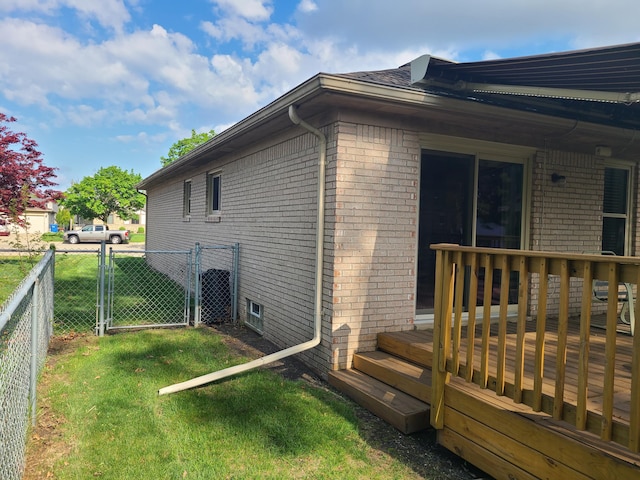 3393 Kevin Cir, Warren, MI 48092 - view of side of property with a wooden deck, a gate, and brick siding