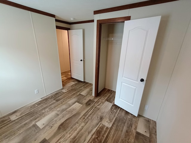 770 129th Ave Unit 4, Shelbyville, MI 49344 - unfurnished bedroom with wood finished floors and crown molding