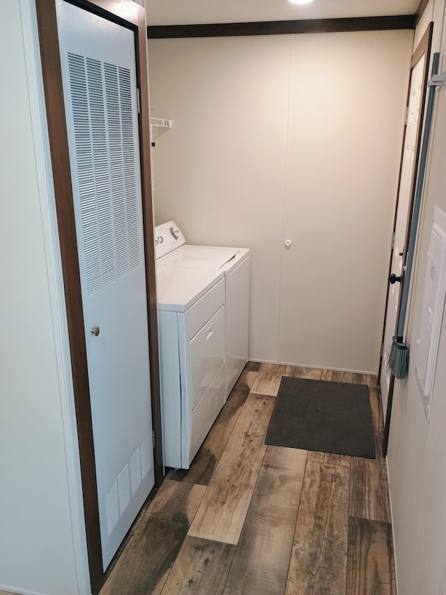 770 129th Ave Unit 4, Shelbyville, MI 49344 - laundry room with a heating unit, light wood finished floors, and washing machine and dryer