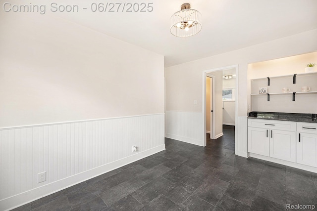 22252 Dale Allen St, Mount Clemens, MI 48035 - kitchen featuring dark countertops, a wainscoted wall, open shelves, a chandelier, and white cabinets