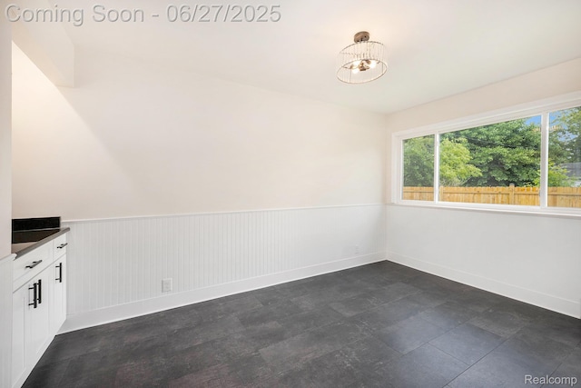 22252 Dale Allen St, Mount Clemens, MI 48035 - unfurnished dining area with a wainscoted wall and a chandelier