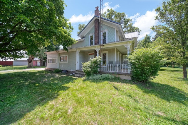 15379 Howard Rd, Hanover, MI 49241 - view of front of house featuring covered porch, a chimney, and a front lawn
