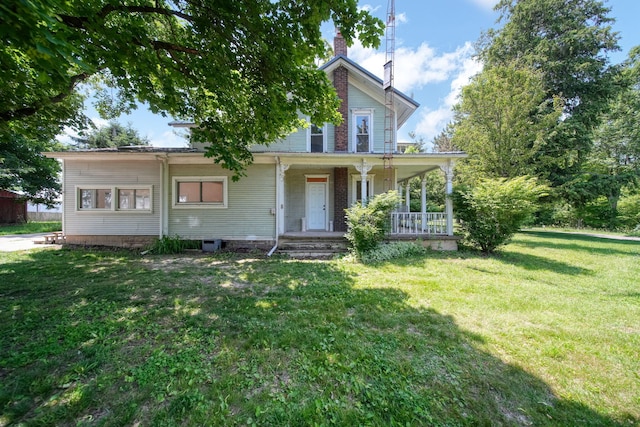 15379 Howard Rd, Hanover, MI 49241 - view of front of house featuring covered porch, a front lawn, and a chimney