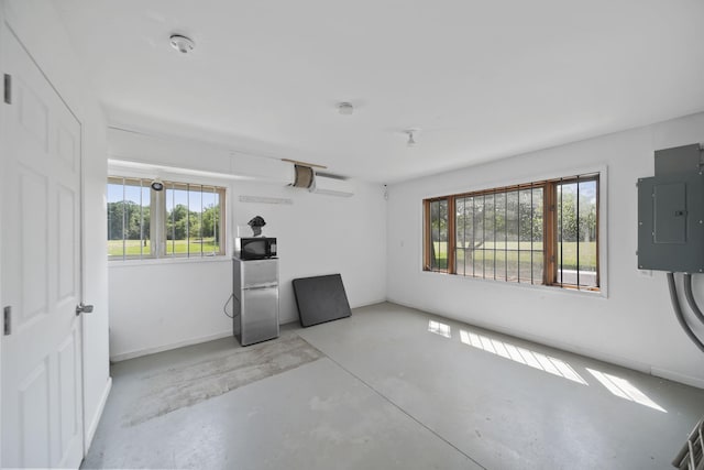 15379 Howard Rd, Hanover, MI 49241 - spare room with plenty of natural light, electric panel, concrete flooring, and a smoke detector