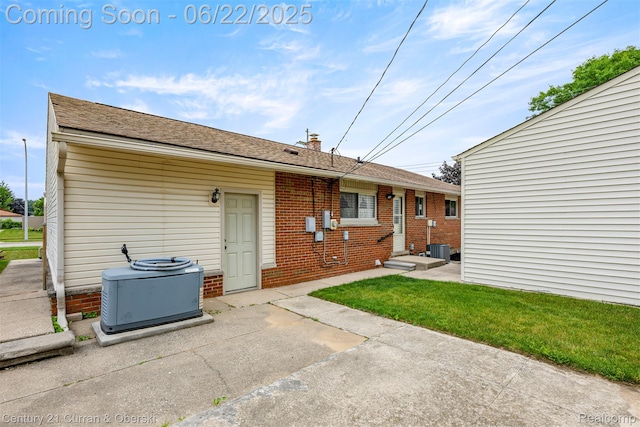 33911 Pawnee St, Westland, MI 48185 - back of house with brick siding, a chimney, and a patio