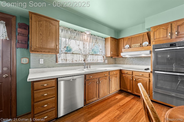 33911 Pawnee St, Westland, MI 48185 - kitchen featuring appliances with stainless steel finishes, light wood finished floors, tasteful backsplash, and light countertops