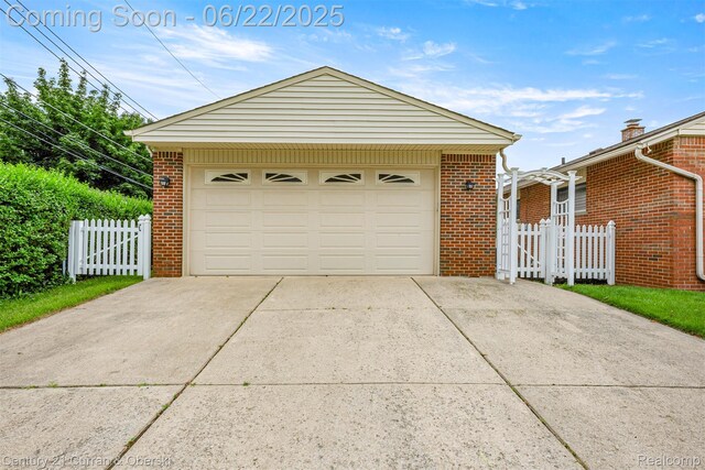 33911 Pawnee St, Westland, MI 48185 - garage featuring a gate and concrete driveway