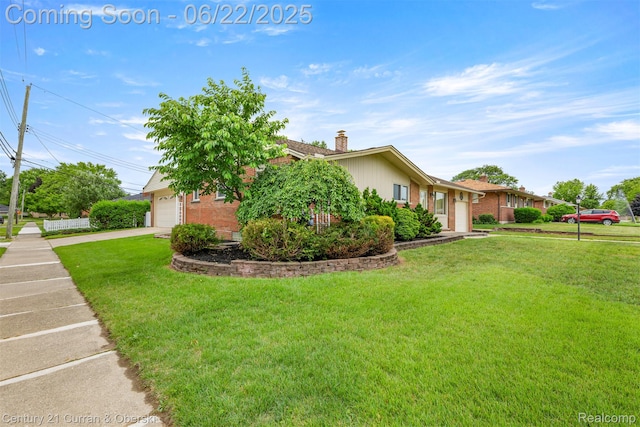 33911 Pawnee St, Westland, MI 48185 - view of home's exterior featuring brick siding, a chimney, a yard, and a garage