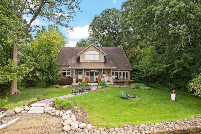 14967 S Shore Dr, Addison, MI 49220 - view of front of home with a front lawn, a shingled roof, and an outdoor fire pit