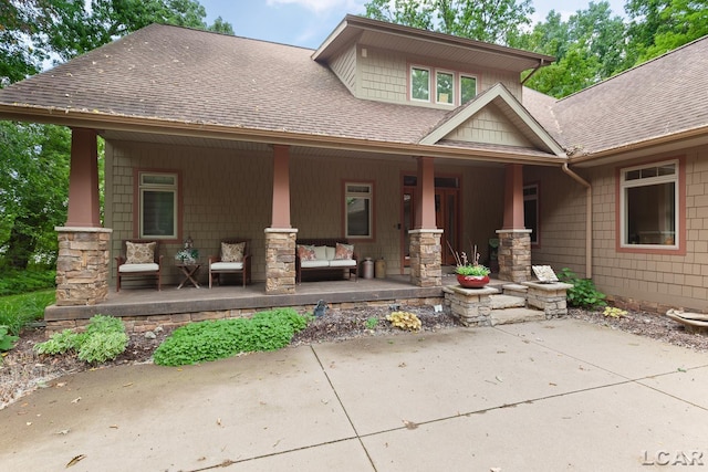 14967 S Shore Dr, Addison, MI 49220 - view of front facade featuring a porch, roof with shingles, and stone siding