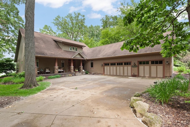 14967 S Shore Dr, Addison, MI 49220 - view of front of property with an attached garage, driveway, covered porch, and a shingled roof