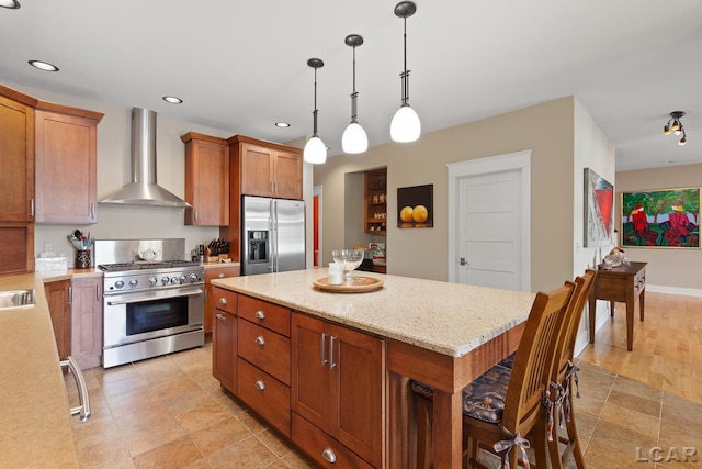 14967 S Shore Dr, Addison, MI 49220 - kitchen with appliances with stainless steel finishes, wall chimney range hood, brown cabinets, a center island, and recessed lighting