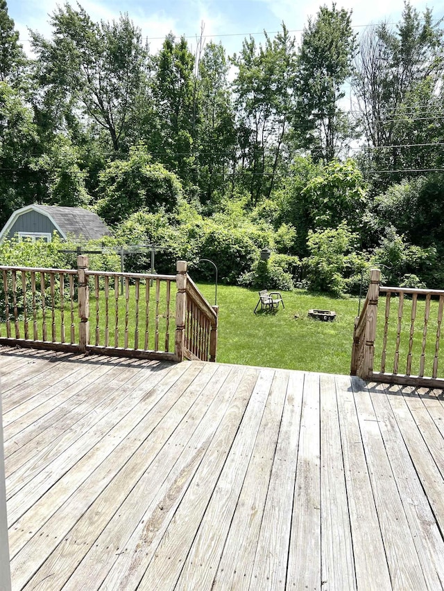 5425 Westchester Dr, Flint, MI 48532 - wooden terrace with a yard, a fire pit, and a shed