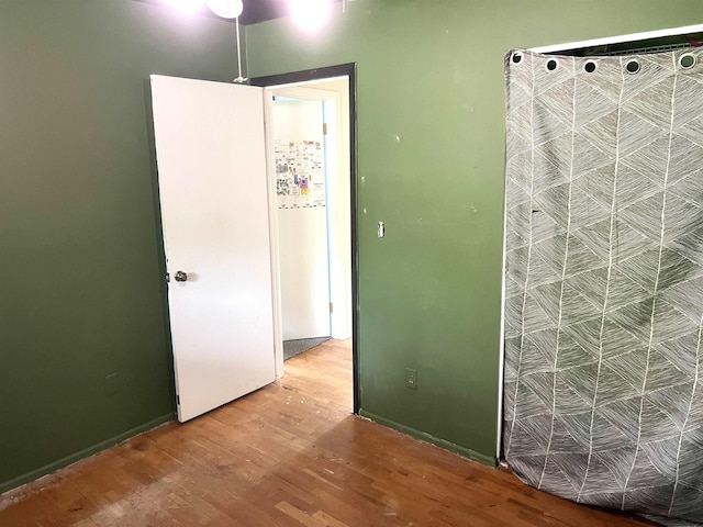 5425 Westchester Dr, Flint, MI 48532 - unfurnished bedroom featuring wood finished floors and baseboards