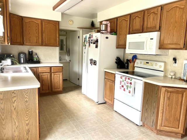 5425 Westchester Dr, Flint, MI 48532 - kitchen featuring white appliances and brown cabinetry