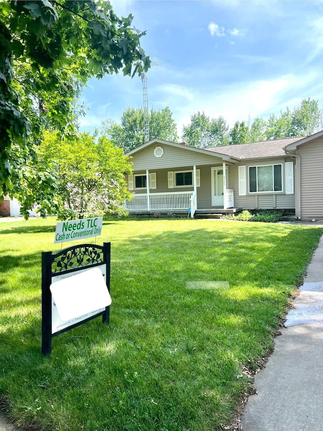 5425 Westchester Dr, Flint, MI 48532 - view of front of house featuring covered porch and a front yard